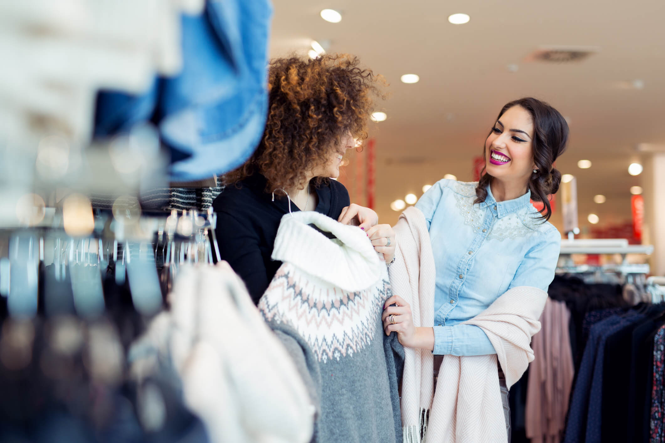 Happy women shopping in a boutique for clothes